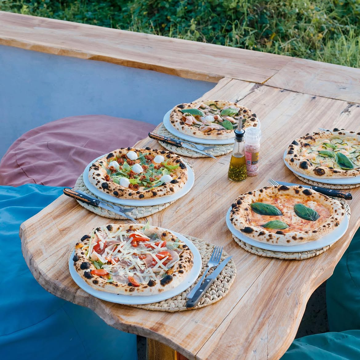 Wood-fired pizzas on a wooden table at Sunset Lab Watamu